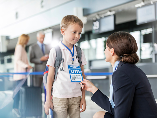 UM, unaccompanied minor, pass and child with air flight attendant at airport